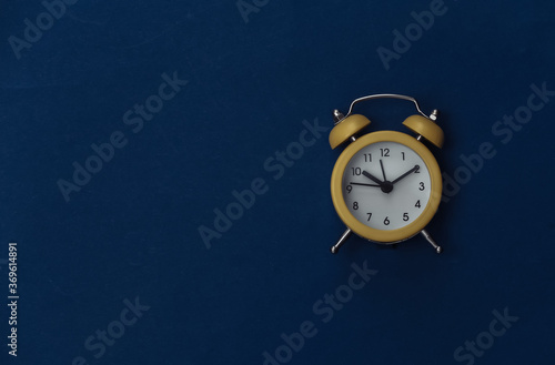 Wallpaper Mural Yellow retro alarm clock on classic blue background. Copy space. Top view. Minimalism Torontodigital.ca