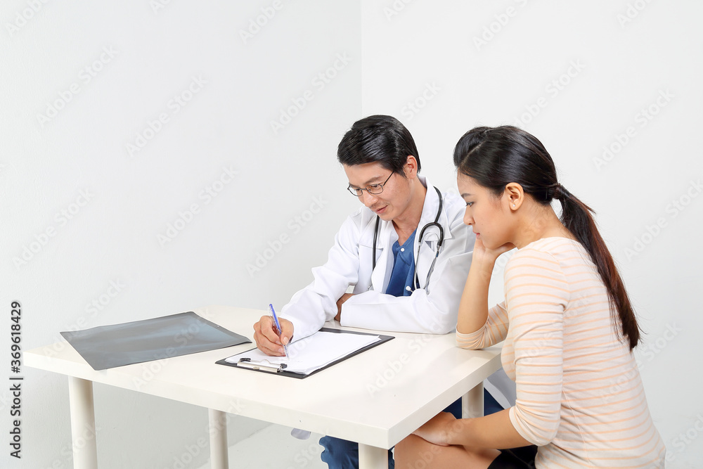 Young Asian male doctor wearing apron uniform stethoscope female patient talk discuss cheek Young Asian male doctor wearing apron uniform stethoscope female patient talk discuss cheek