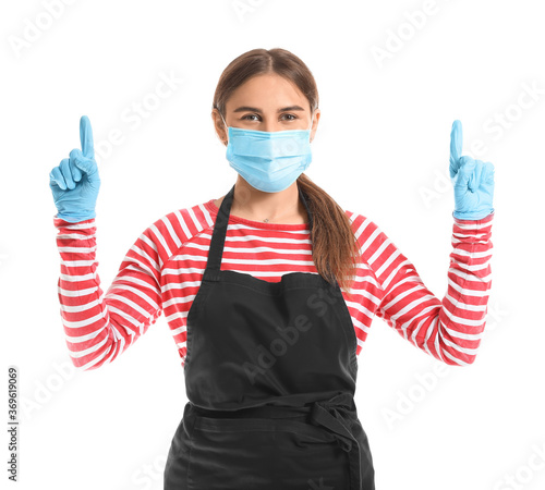 Female barista in mask poin...