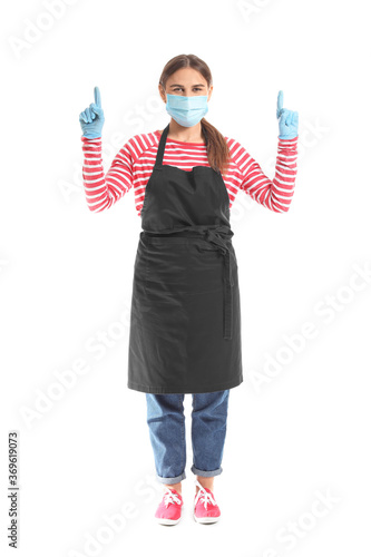 Female barista in mask poin...
