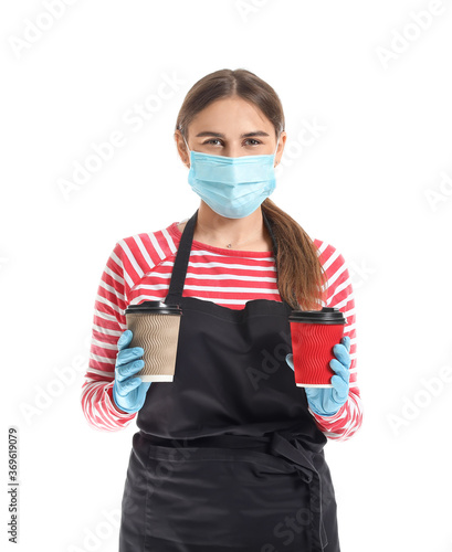 Female barista in mask on w...