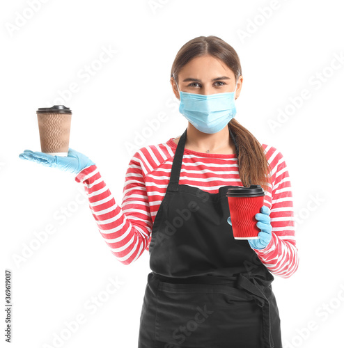 Female barista in mask on w...