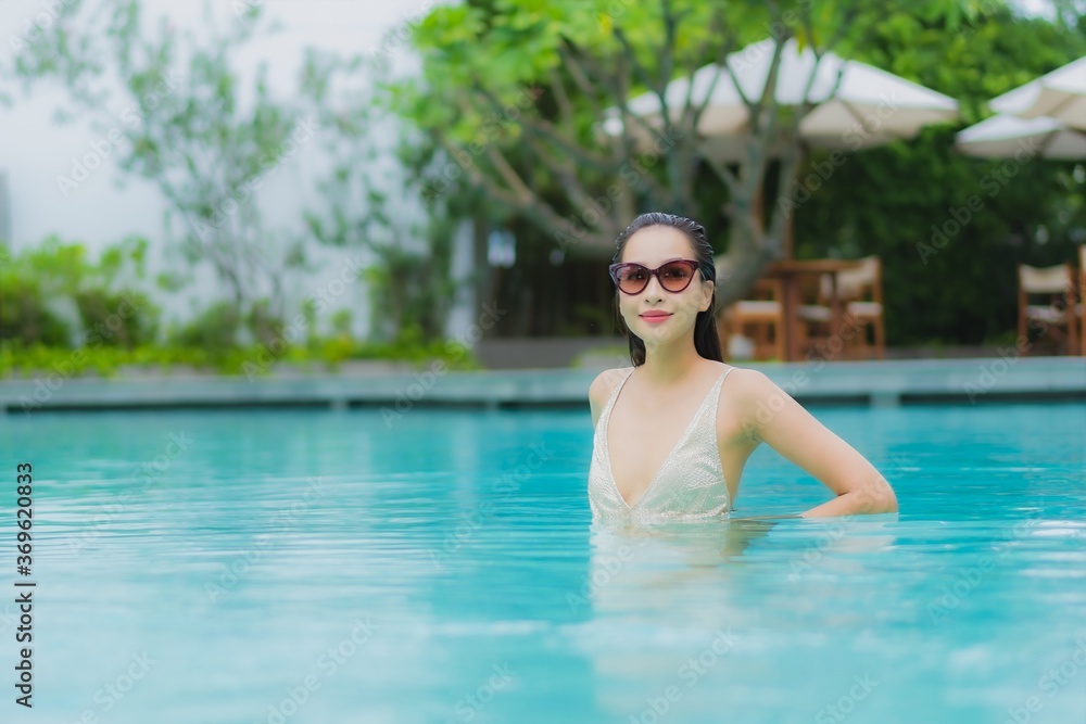 Portrait beautiful young asian woman relax smile around outdoor swimming pool