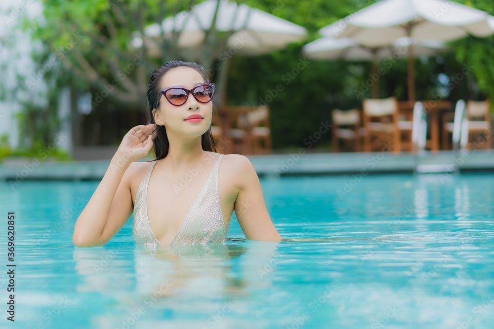 Portrait beautiful young asian woman relax smile around outdoor swimming pool