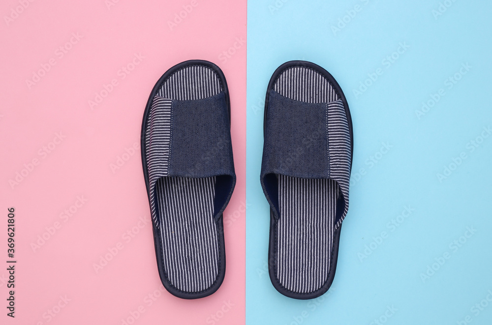 Men's sleeping room slippers on pink blue pastel background. Top view Men's sleeping room slippers on pink blue pastel background. Top view