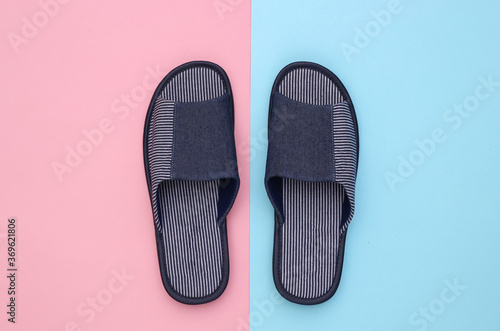 Men's sleeping room slippers on pink blue pastel background. Top view