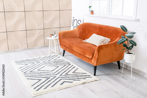 Fotografie Interior of modern room with sofa and beautiful carpet