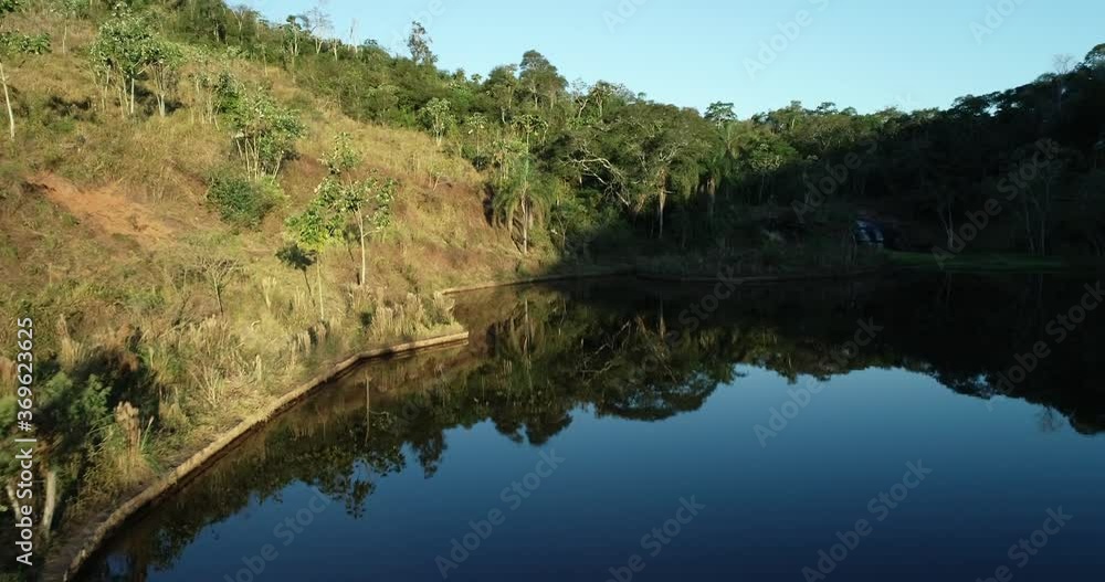 Drone flying low over a beautiful lake with reflection of nature around, peace, tranquility, love, in 4K resolution Drone flying low over a beautiful lake with reflection of nature around, peace, tranquility, love, in 4K resolution