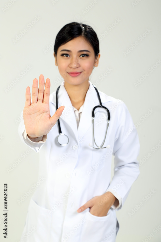 Young Asian female doctor wearing apron stethoscope stop hand sing Young Asian female doctor wearing apron stethoscope stop hand sing