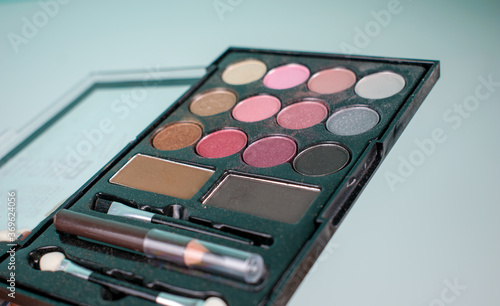 Makeup beauty cosmetics tools, products & facial cosmetics, brush, sculptor, eye shadow, highlighter palette, shadows and pencil for eyebrows isolated on light background.