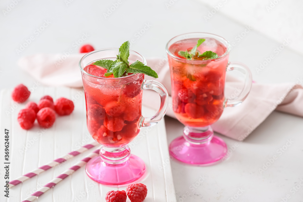 Cups of cold raspberry tea on white background Cups of cold raspberry tea on white background