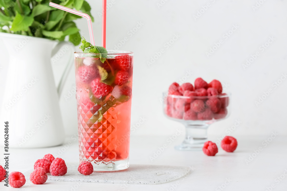 Glass of cold raspberry tea on white background Glass of cold raspberry tea on white background