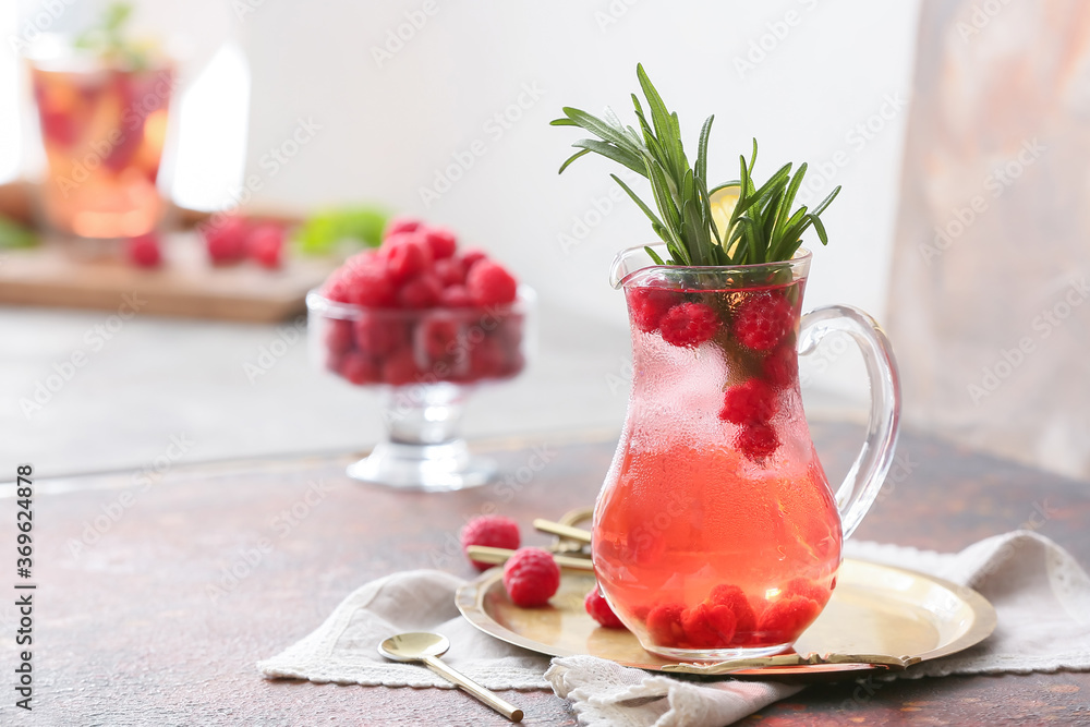 Jug of cold raspberry tea on table - obrazy, fototapety, plakaty 