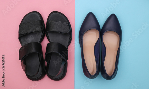 Leather women's sandals and high heel shoes on pink blue background. Top view. Flat lay