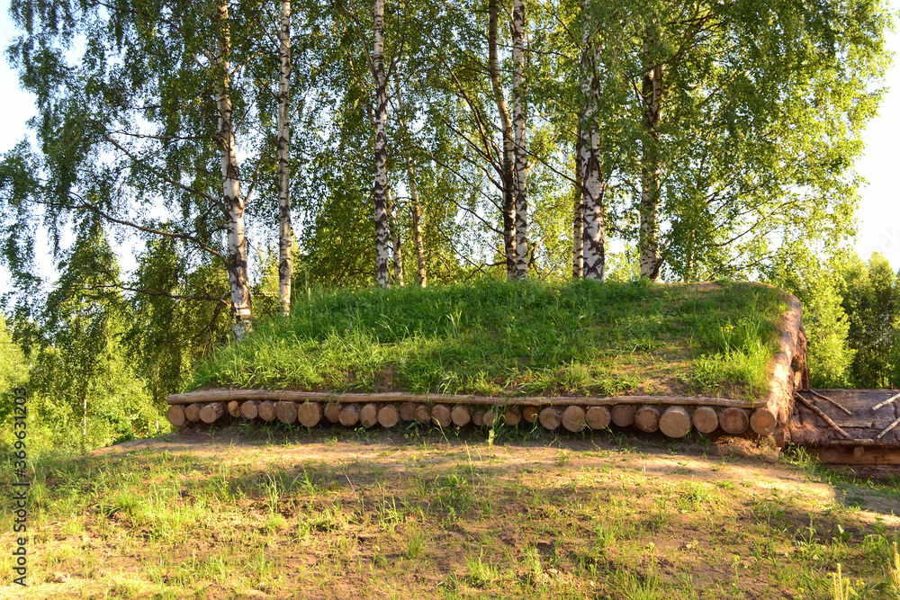 Wooden roof made of pine logs, covered with earthen decking. Dugout in the forest for travelers' rest and overnight stay. Wooden roof made of pine logs, covered with earthen decking. Dugout in the forest for travelers' rest and overnight stay.