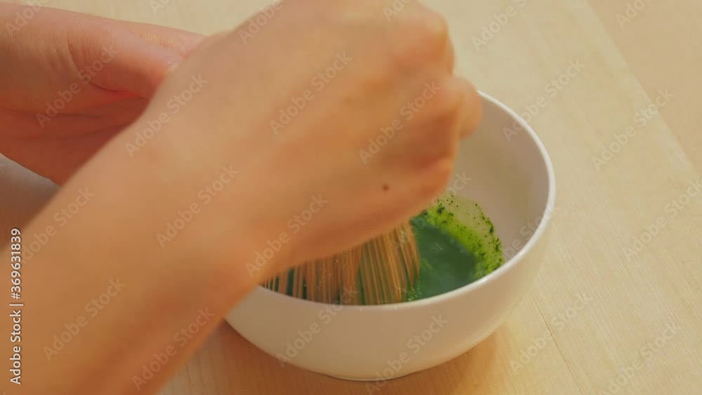 Using tea whisk making Matcha in a traditional Japanese culture tea ceremony Using tea whisk making Matcha in a traditional Japanese culture tea ceremony