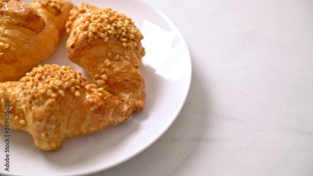 fresh croissant with peanut on plate fresh croissant with peanut on plate