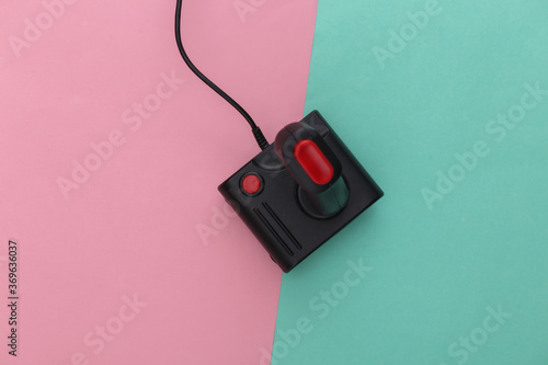 Retro joystick on pink blue pastel background. Gaming, video game competition