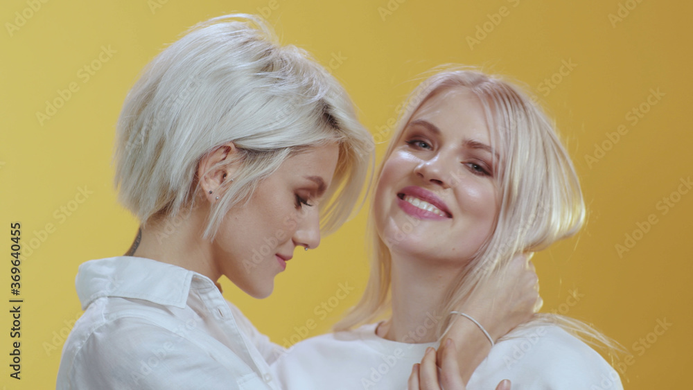 Nice Beautiful Lesbian Couple Of Lgbt Cute Blonde Girls Wearing White Shirts Embrace Each Other
