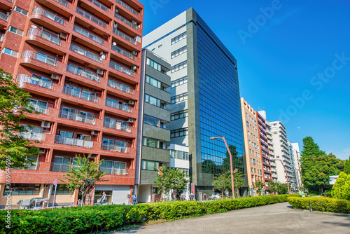 Wall Mural TOKYO, JAPAN - MAY 20, 2016: Modern colourful buildings of Shinjuku on a sunny s