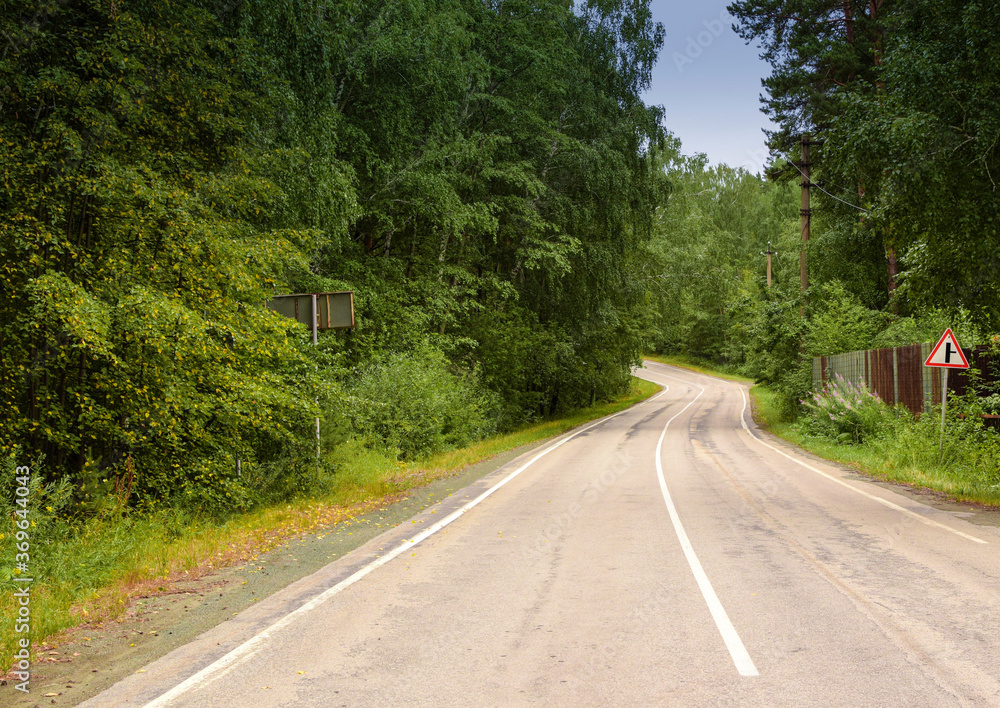 Empty twisting road. Dangerous turn of the road in the forest.Beautiful forest landscape. Empty twisting road. Dangerous turn of the road in the forest.Beautiful forest landscape.
