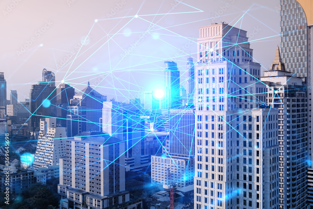 Obraz premium Hologram of abstract technology glowing icons, panoramic cityscape of Bangkok at sunset, Asia. The concept of worlds technological changes. Double exposure.