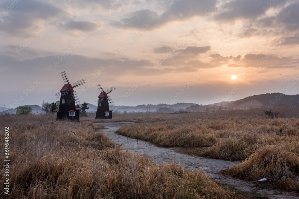 Fototapeta premium The beautiful landscape of windmill town in the early morning at dawn.