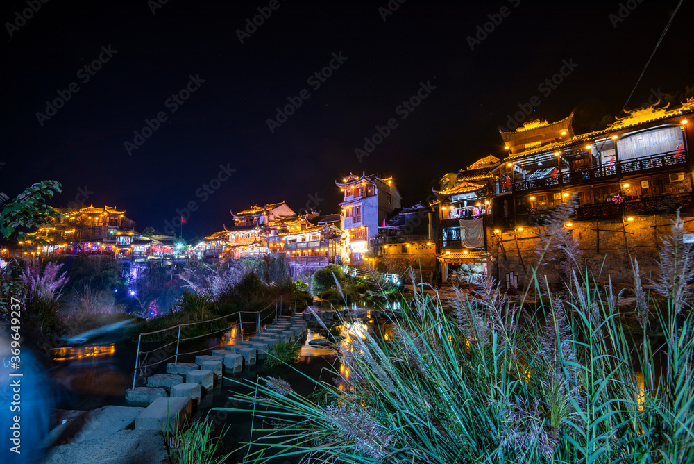 Furong Ancient Town illuminated at night. Amazing beautiful landscape scene of Furong Ancient Town (Furong Zhen, Hibiscus Town), China