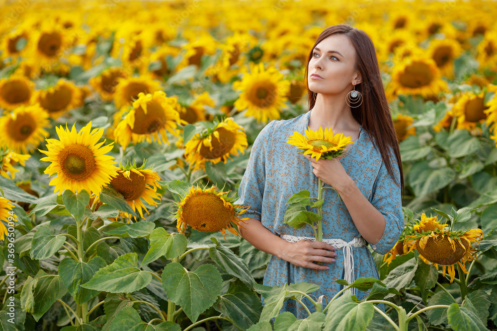 Beauty joyful girl enjoying nature on the field of sunflowers at sunset. Beauty joyful girl enjoying nature on the field of sunflowers at sunset.