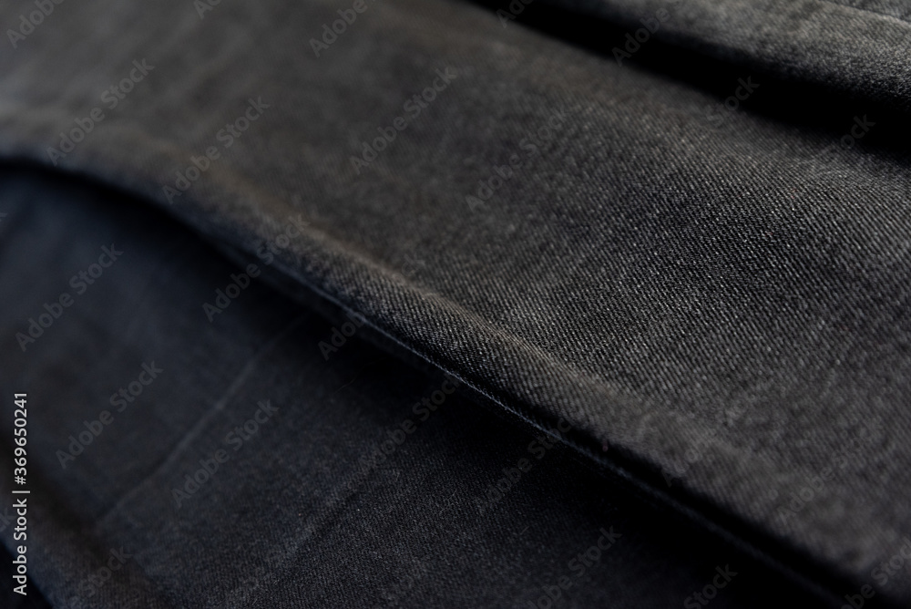 Detail of different black denim fabrics. Black jeans.