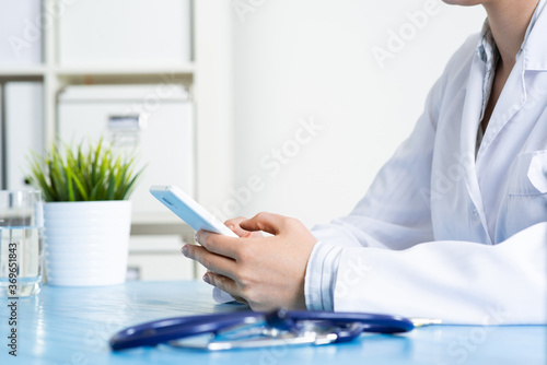 Close up of doctor hands holding mobile phone