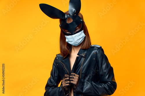  Female rabbit mask posing sexually in a medical mask from coronavirus