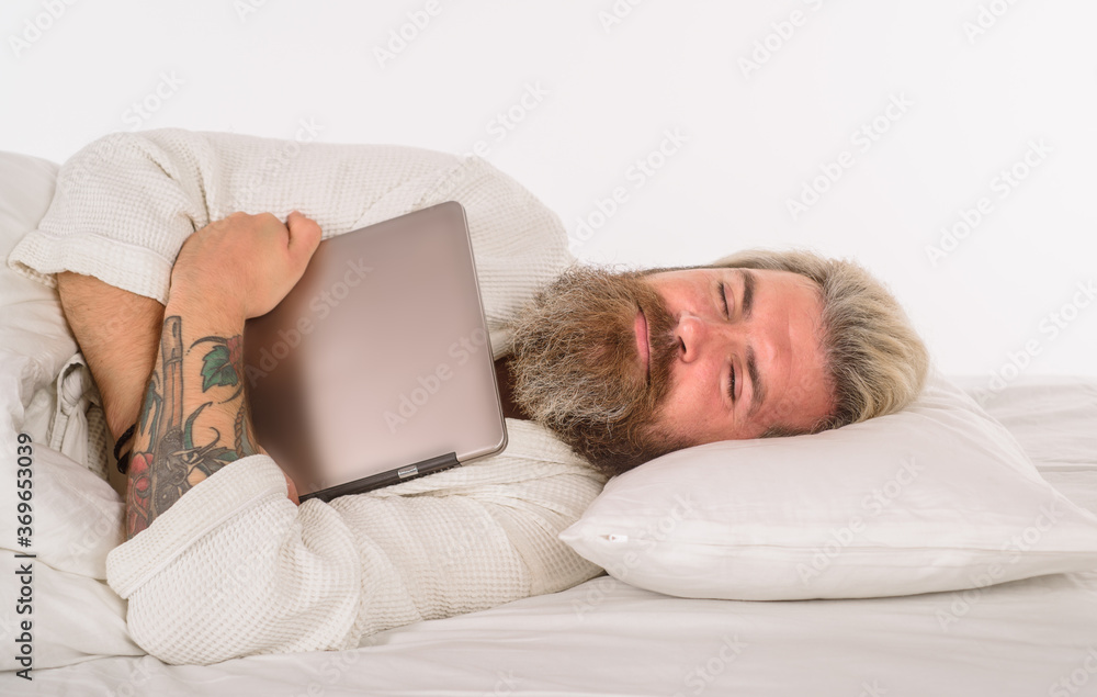Sleep. Bearded man sleep with laptop. Work from home. Bearded man in bed. Morning and wake up. Man sleeping in comfortable bed at home. Man sleeping on white bed. Sleep. Bearded man sleep with laptop. Work from home. Bearded man in bed. Morning and wake up. Man sleeping in comfortable bed at home. Man sleeping on white bed.