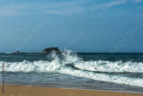 The big breaking waves during a strom at the beautiful summer sea shore background the blue sky and horizon