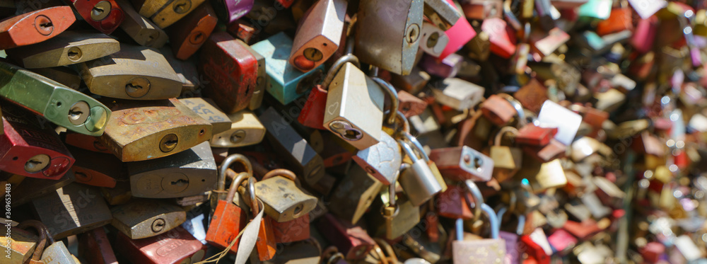 Lovers hang locks on a bridge in city Cologne. Natural bright background. Suitable as bright background, template, poster, banner.