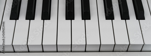 Photography of black and white piano keys. Close up frontal view.  photo