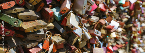 Lovers hang locks on a bridge in city Cologne. Natural bright background. Suitable as bright background  template  poster  banner.