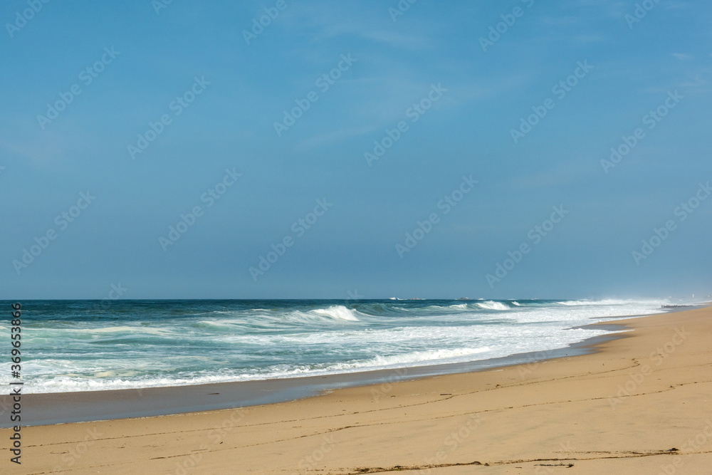 The big breaking waves during a strom at the beautiful summer sea shore background the blue sky and horizon