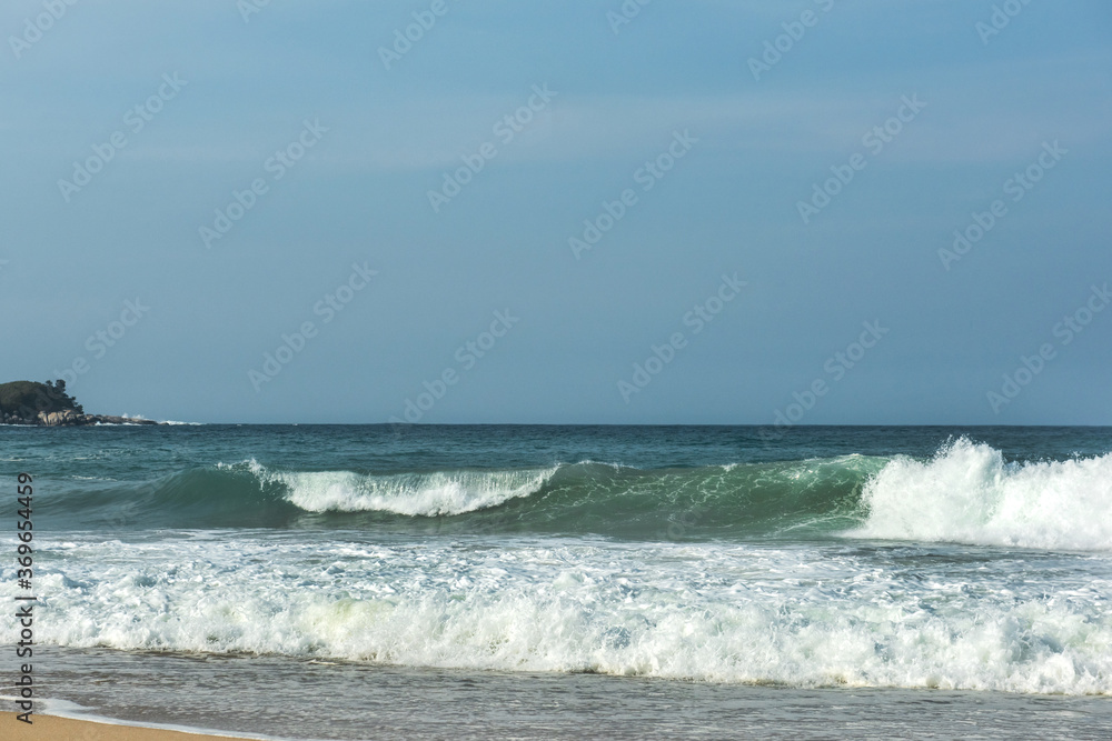 The big breaking waves during a strom at the beautiful summer sea shore background the blue sky and horizon The big breaking waves during a strom at the beautiful summer sea shore background the blue sky and horizon