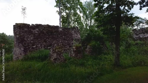 Medieval Castle Ruins in Latvia Rauna.  Aerial View Over Old Stoune Brick Wall of Raunas Castle Where Was Living Archbishop in Middle Age in Latvia. Dron 4k Video photo