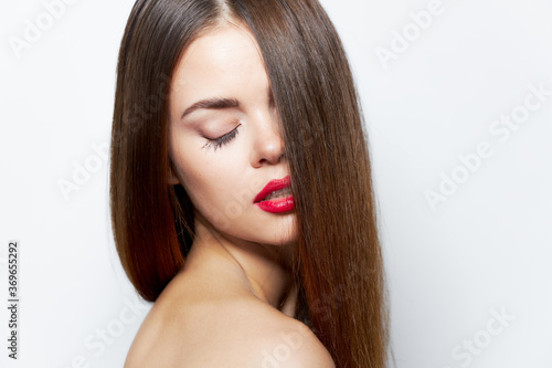 Attractive woman Bare shoulders long hairstyle on the face red lips 