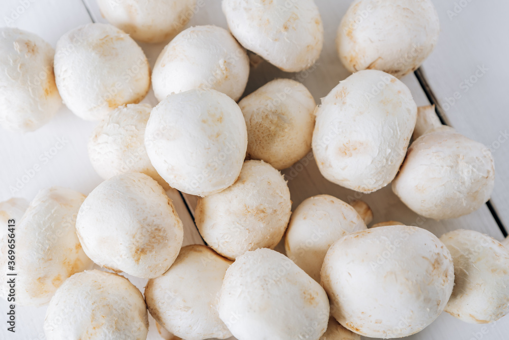 Several mushrooms on a white wooden background Several mushrooms on a white wooden background
