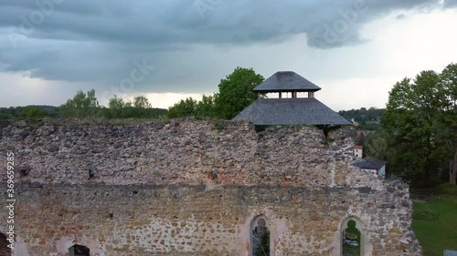 Medieval Castle Ruins in Latvia Rauna.  Aerial View Over Old Stoune Brick Wall of Raunas Castle Where Was Living Archbishop in Middle Age in Latvia. Dron 4k Video photo