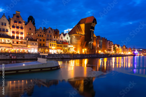 Amazing architecture of Gdansk old town over the Motlawa River at night.