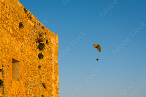 Flying paraglider over Menorca island. Spain