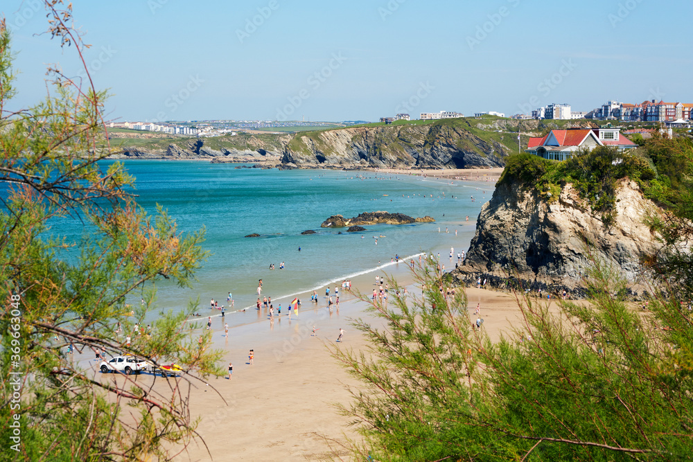 Holidaymakers and sunbathers on Newquay beach in Cornwall