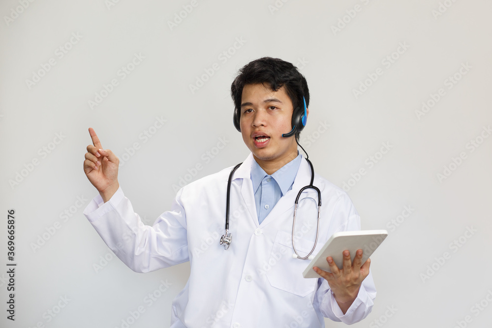Young asian doctor with stethoscope talking with patient on white background Young asian doctor with stethoscope talking with patient on white background