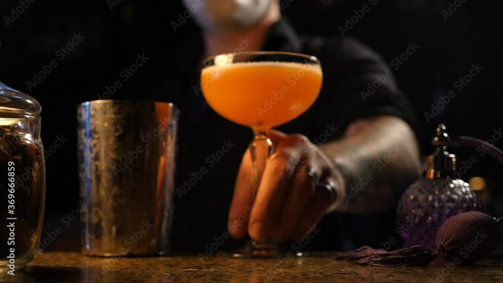 the bartender prepares a delicious cocktail the bartender prepares a delicious cocktail