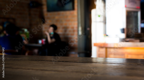 Wooden top table with bokeh light effect and blur restaurant on background, blur background