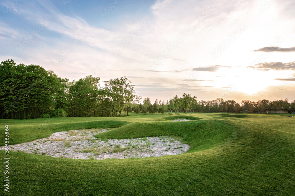 Sand bunkers at the beautiful golf course at the ocean side at sunset, sunrise time. Art noise